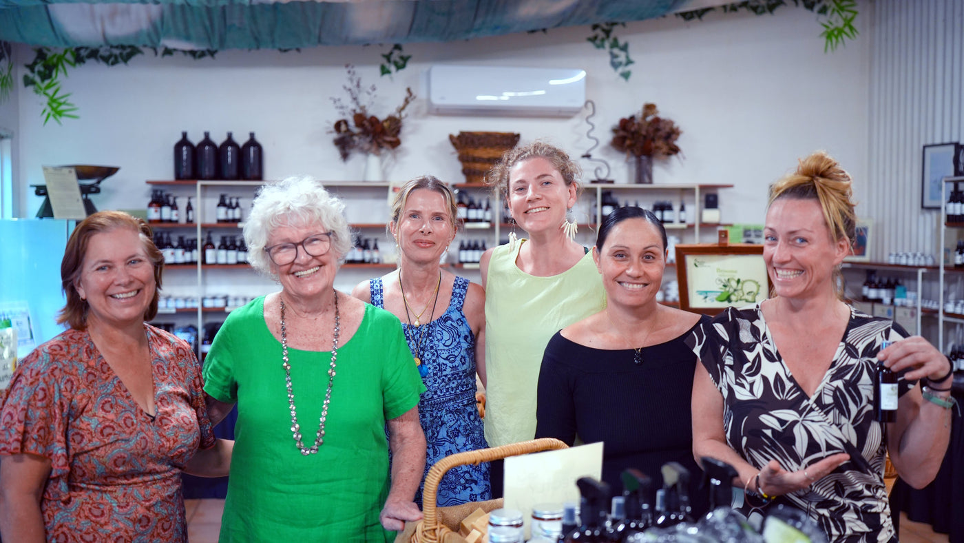Group of women posing together in a store setting